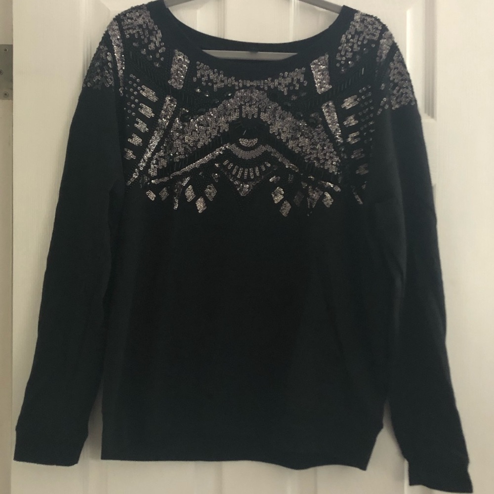 Black sweatshirt style with sequin.